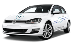 Vit Volkswagen-bil med "LF"-logga på dörr och motorhuv. Texten på sidan lyder "LondonFitnessStudio.co.uk", som visar upp en slående design som inbjuder dig att lära dig mer *om oss*.